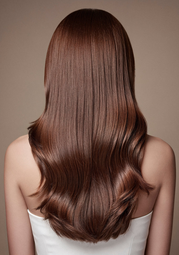 A model with long, shiny, healthy hair is shown holding Sujal Herbal Bhringraj & Amla Shampoo and Hair Oil bottles. The packaging is herbal-themed with green and natural colors, representing 100% herbal hair care made for all hair types